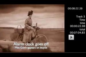 The clocks of "Time" all go off to signify Miss Gultch's arrival on bicycle...